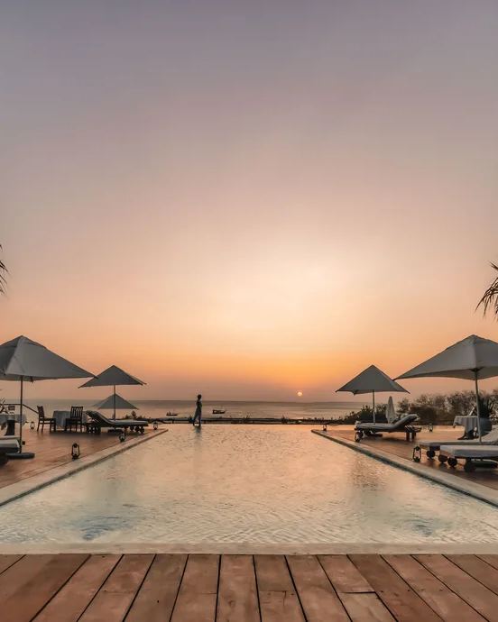 Infinity pool at Kilindi Zanzibar at sunset over the ocean